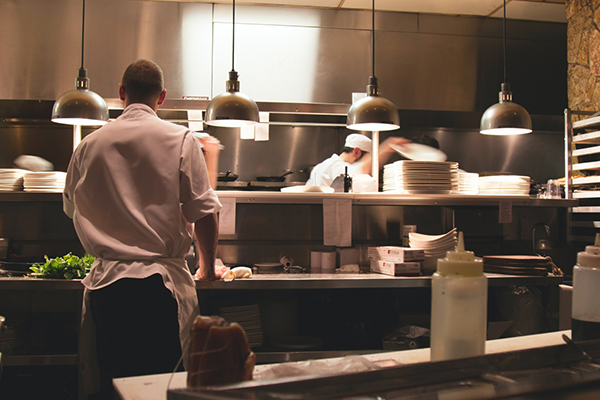 two people working in a kitchen