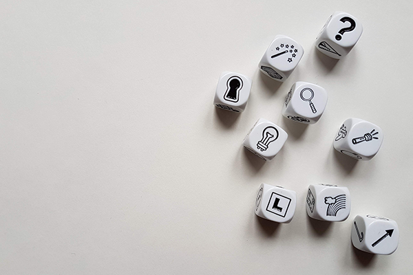 Gaming dice laying on a surface showing different symbols.