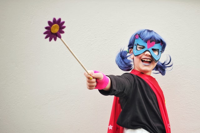 Young girl dressed as a superhero